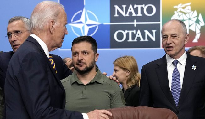 From left, NATO Secretary General Jens Stoltenberg, United States President Joe Biden, Ukraine&#x27;s President Volodymyr Zelenskyy and NATO Deputy Secretary General Mircea Geoana stand during a meeting of the NATO-Ukraine Council during a NATO summit in Vilnius, Lithuania, Wednesday, July 12, 2023. NATO leaders gathered Wednesday to launch a highly symbolic new forum for ties with Ukraine, after committing to provide the country with more military assistance for fighting Russia but only vague assurances of future membership. (AP Photo/Pavel Golovkin)