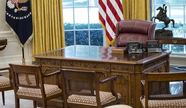 The Resolute Desk is seen in the newly refreshed Oval Office of the White House in Washington, Tuesday, Aug. 22, 2017, during a media tour. During an update of the West Wing, the Oval Office got new wallpaper and the floors were refinished. The draperies and furnishings are all part of the White House collection and were used by previous presidents. (AP Photo/Carolyn Kaster)