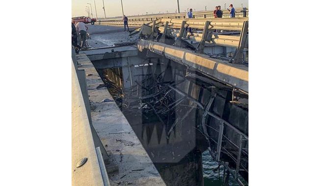 This photo released by Ostorozhno Novosti on Monday, July 17, 2023, reportedly shows damaged parts of an automobile link of the Crimean Bridge connecting Russian mainland and Crimean peninsula over the Kerch Strait not far from Kerch, Crimea. Traffic on the key bridge connecting Crimea to Russia&#x27;s mainland was halted on Monday, July 17, after reports of explosions that Crimean officials said were from a Ukrainian attack.(Ostorozhno Novosti via AP)