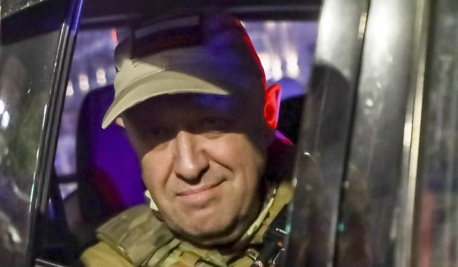 Yevgeny Prigozhin, the owner of the Wagner Group military company, looks from a military vehicle leaving an area of the HQ of the Southern Military District in a street in Rostov-on-Don, Russia, on June 24, 2023. Putin recounted to Kommersant his own version of a Kremlin event attended by 35 Wagner commanders, including the group&#x27;s chief, Yevgeny Prigozhin, on June 29. That meeting came just five days after Prigozhin and his troops staged a stunning but short-lived rebellion against Moscow authorities. (AP Photo, File)