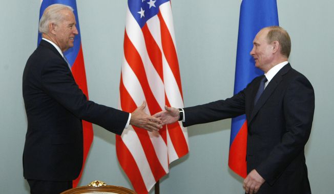 In this March 10, 2011, file photo, then-Vice President of the United States Joe Biden, left, shakes hands with Russian Prime Minister Vladimir Putin in Moscow, Russia. (AP Photo/Alexander Zemlianichenko, File)