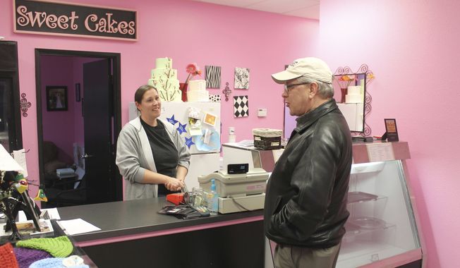 In this Feb. 5, 2013, file photo, Melissa Klein, co-owner of Sweet Cakes by Melissa, in Gresham, Ore., tells a customer that the bakery has sold out of baked goods for the day. (Everton Bailey Jr./The Oregonian via AP, File)