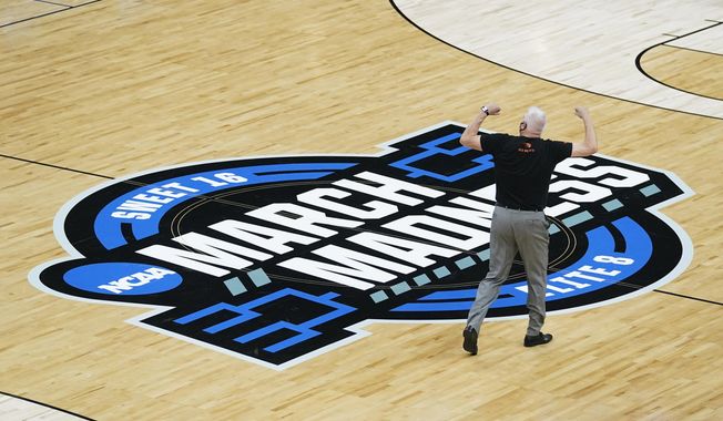 FILE - Oregon State head coach Wayne Tinkle celebrates as he walks off the court after a Sweet 16 game against Loyola Chicago in the NCAA men&#x27;s college basketball tournament at Bankers Life Fieldhouse, Saturday, March 27, 2021, in Indianapolis. In college hoops, where virtually all success is measured by how a team, or conference, fares in March Madness, the 2022-23 campaign about to kick off looks a lot like business as usual. (AP Photo/Darron Cummings, File)