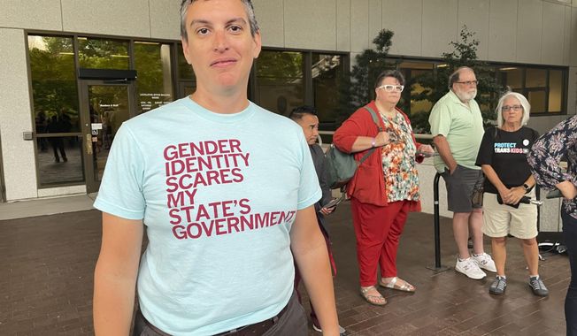 D Sellars, a nonbinary parent from Fuquay-Varina, N.C., stands outside the Legislative Office Building in Raleigh, N.C., Tuesday, June 20, 2023. Sellars was among dozens of LGBTQ+ people who showed up to speak in committee against a bill restricting gender-affirming care access but was not given time to testify. (AP Photo/Hannah Schoenbaum)