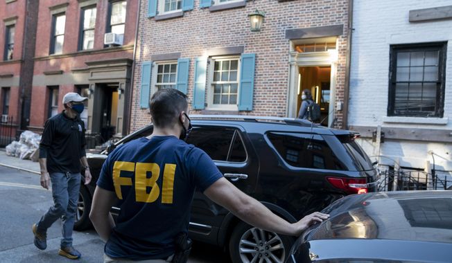 Federal agents enter and exit a property related to Russian oligarch Oleg Deripaska, Tuesday, Oct. 19, 2021, in New York. Earlier, an agency spokesperson says FBI agents were at a home in Washington connected to Deripaska to carry out &amp;quot;court-authorized law enforcement activity.&amp;quot; (AP Photo/John Minchillo) **FILE**