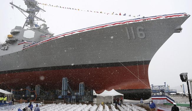Snow falls on the future USS Thomas Hudner, a U.S. Navy destroyer named after Korean War veteran Thomas Hudner, during a christening ceremony at Bath Iron Works in Bath, Maine, April 1, 2017. The U.S. is sending additional fighter jets and a warship to the Strait of Hormuz and the Gulf of Oman to increase security in the wake of Iranian attempts to seize commercial ships there. The Pentagon said Monday that the USS Thomas Hudner, a destroyer, and a number of F-35 fighter jets will be heading to the area. The Hudner had been in the Red Sea. (AP Photo/Mary Schwalm, File)