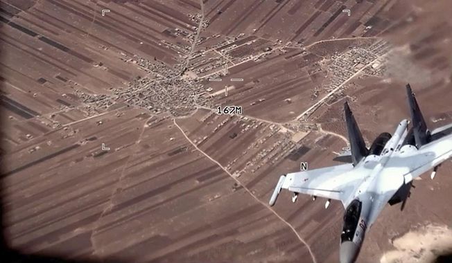 In this image from video released by the U.S. Air Force, a Russian Su-35 flies near a U.S. Air Force MQ-9 Reaper drone on July 5, 2023, over Syria. U.S. officials say that a Russian fighter jet flew very close to a manned U.S. surveillance aircraft over Syria Sunday, July 16, forcing it to go through the turbulent wake and putting the lives of the four-person American crew in danger.(U.S. Air Force via AP)