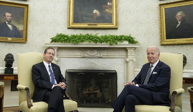 President Joe Biden and Israel&#x27;s President Isaac Herzog listen to reporters&#x27; questions as they meet in the Oval Office of the White House in Washington, Tuesday, July 18, 2023. (AP Photo/Susan Walsh)