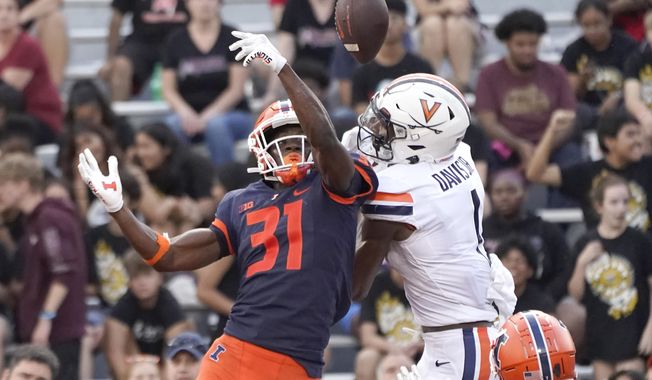 Illinois defensive back Devon Witherspoon breaks up a pass in the end zone intended for Virginia&#x27;s Lavel Davis Jr., during the second half of an NCAA college football game Saturday, Sept. 10, 2022, in Champaign, Ill. Illinois won 24-3. (AP Photo/Charles Rex Arbogast) **FILE**
