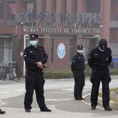 In this file photo, security personnel gather near the entrance of the Wuhan Institute of Virology during a visit by the World Health Organization team in Wuhan in China&#x27;s Hubei province on Wednesday, Feb. 3, 2021. (AP Photo/Ng Han Guan) ** FILE **