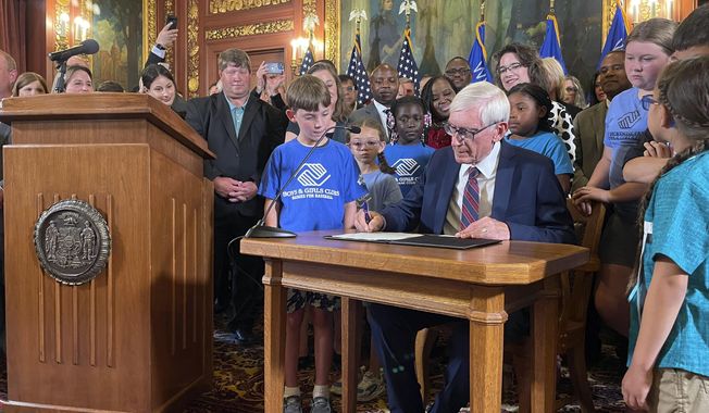 Democratic Wisconsin Gov. Tony Evers signed a two-year spending plan into law, Wednesday, July 5, 2023, in Madison, Wis. The budget was authored by Republicans who control the Legislature, but Evers used his partial veto powers to revise portions of it. (AP Photo/Harm Venhuizen)
