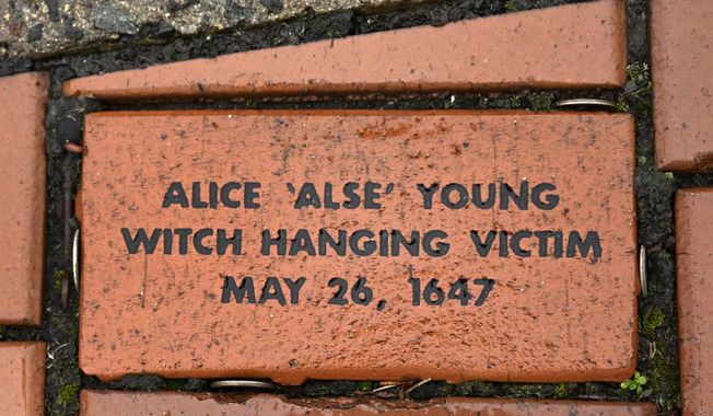In this Tuesday, Jan. 24, 2023 photo, a brick memorializing Alice &#x27;Alse&#x27; Young is placed in a town Heritage Bricks installation in Windsor, Conn. Young was the first person on record to be executed in the 13 colonies for witchcraft. Now, more than 375 years later, amateur historians, researchers and descendants of the accused witches and their accusers, from across the U.S., are urging Connecticut officials to officially acknowledge this dark period of the state&#x27;s colonial history and posthumously exonerate those wrongfully accused and punished. (AP Photo/Jessica Hill)