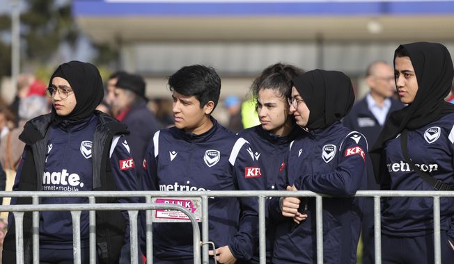 Members of the Afghan women&#x27;s football team attend Morocco&#x27;s practice ahead of the Women&#x27;s World Cup in Melbourne, Australia, Wednesday, July 19, 2023. Some of the team left Afghanistan after the Taliban retook power in 2021 and came out to support the Moroccan women and show that Muslim women belong in sports. (AP Photo/Victoria Adkins)