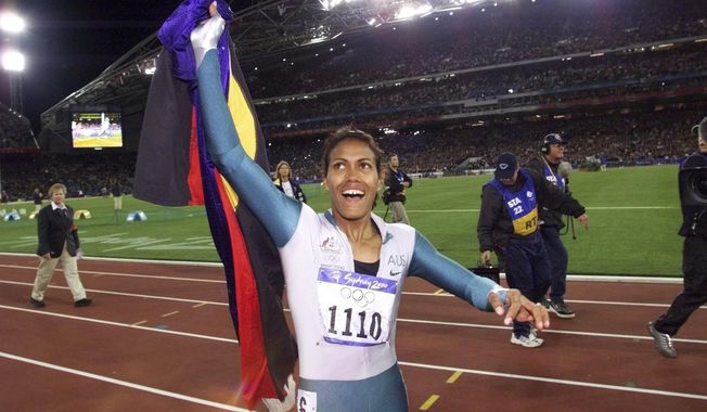 In this Sept. 25, 2000, file photo, Australia&#x27;s Cathy Freeman celebrates winning the women&#x27;s 400-meter race at the Summer Olympics at Olympic Stadium in Sydney. Tony Gustavsson, head coach of Australia&#x27;s national women&#x27;s soccer team, called a meeting. Instead of leading the team through a tactical discussion, he told the players he had different plans for the evening.&quot;They played about a three-minute highlight reel on YouTube of the moment of Cathy Freeman&#x27;s race,&quot; Matildas defender Aivi Luik said. &quot;And by the end of it, there was a lot of emotion going around in the room. (AP Photo/Thomas Kienzle, File)